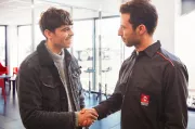 A customer and a mechanic shaking hands